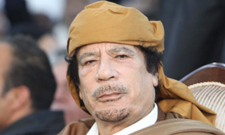 Libyan leader Muammar Gaddafi prays during a ceremony marking the birth of Islam's Prophet Mohammed 