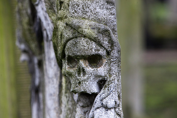 Bunhill fields cemetery: A detail of a skull on the side of a tomb
