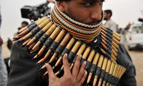 A Libyan rebel fighter wraps himself in ammo