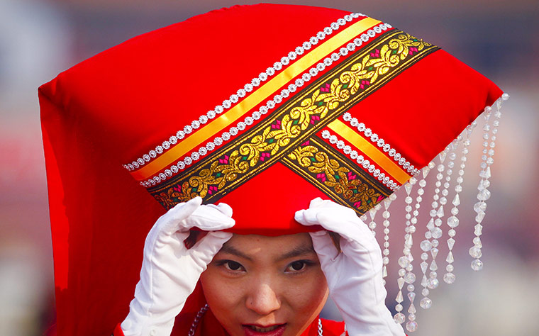 NPC in Beijing: Stewardess adjusts  her hat