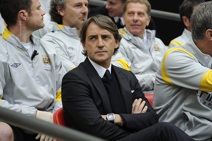 Man City v Man Utd: Roberto Mancini looks pensive ahead of kick off