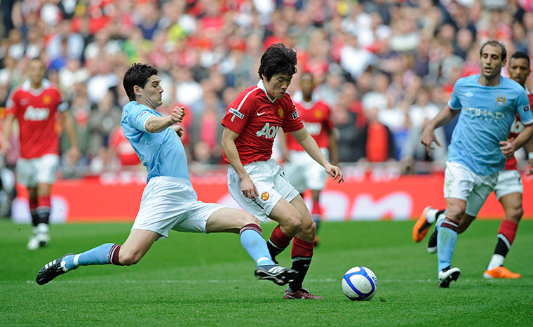 Man City v Man Utd: Gareth Barry sticks out a leg to dispossess Park