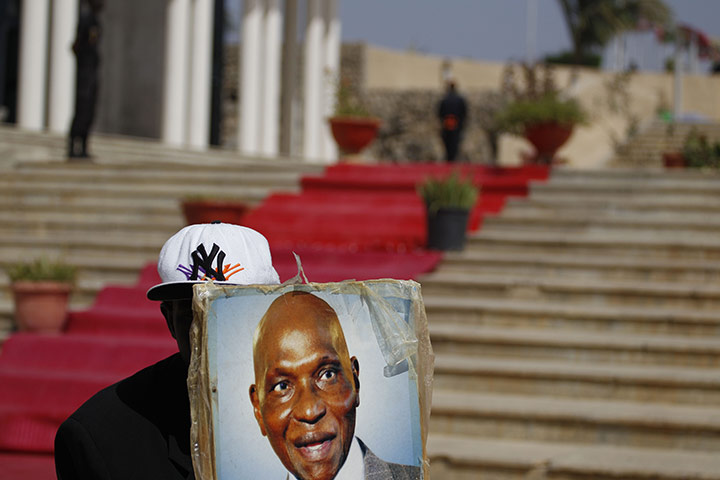 Africa Unrest: A Senegalese supporter of Abdoulaye Wade holds the president's portrait