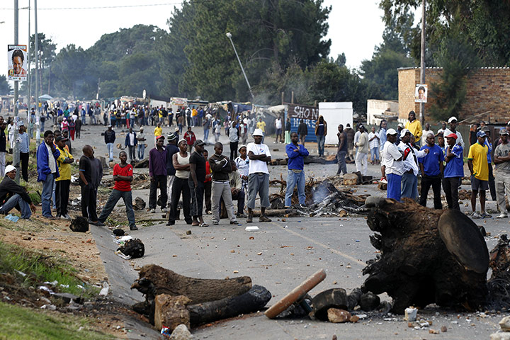 Africa Unrest: Township residents stand near barricades during protests in South Africa