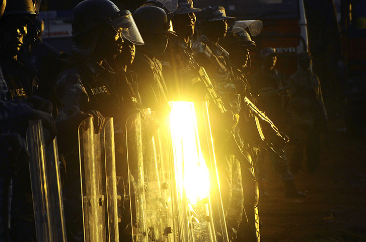 Africa Unrest: Ugandan anti-riot policemen stand guard outside Kasangati Police Station