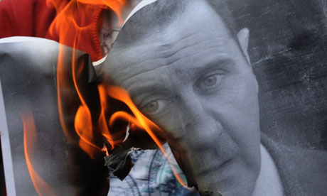 Bashar al-Assad portrait on fire