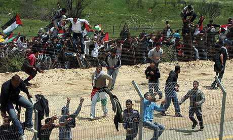 Palestinian protesters cross the Israel-Syria border