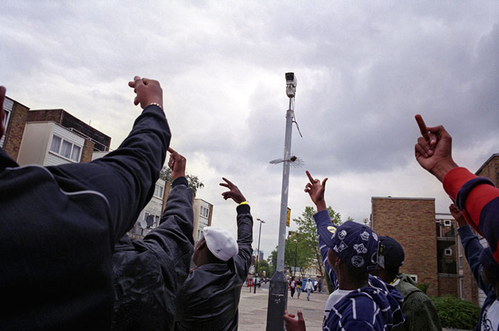 Don't Call Me Urban : Members of Get Money Quick crew walk past a CCTV camera, Kilburn, 2006