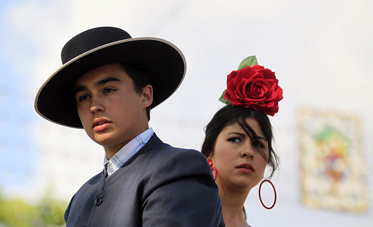Feria de Seville: A man and woman wearing typical Sevillana outfits