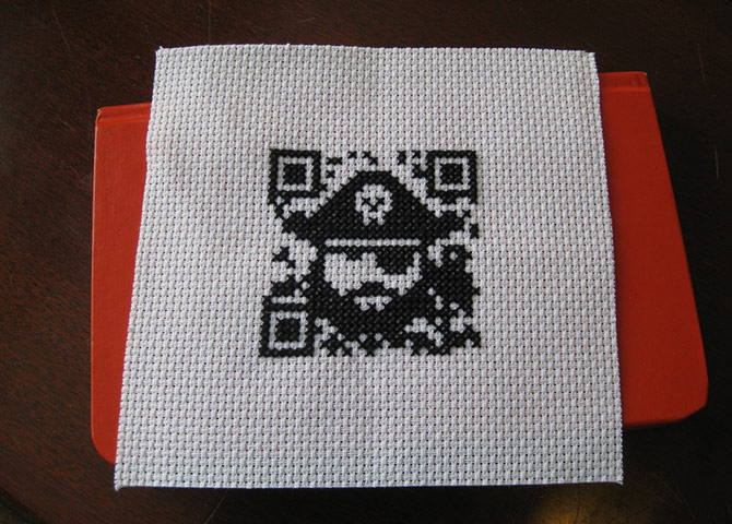 QR-3D: AP^ has reimagined a Threadless T-shirt design in cross stitch