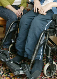 Child in wheelchair with carer