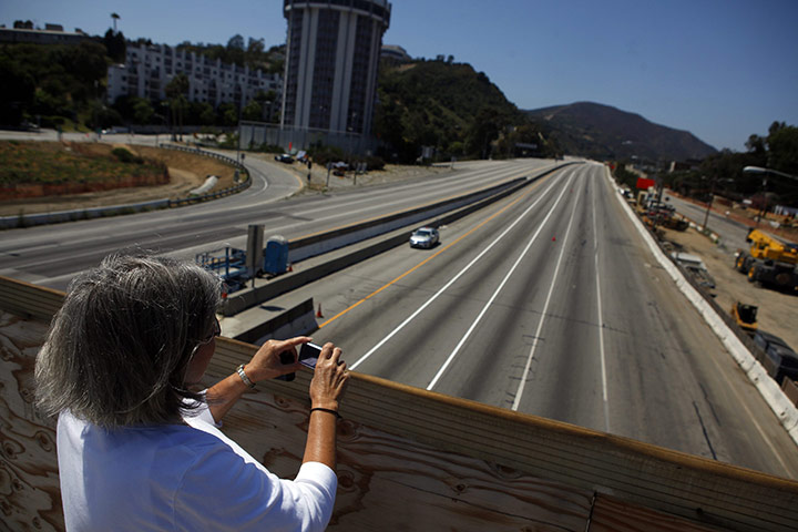 Carmageddon: A woman takes a picture of the closed 405 Freeway in Los Angeles