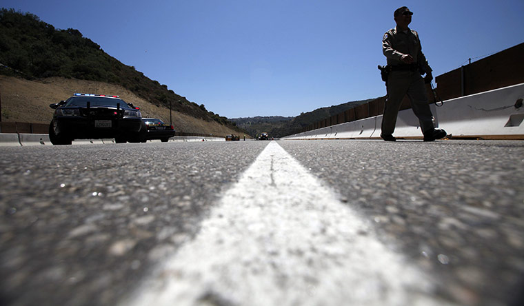 Carmageddon: A California Highway Patrol officer walks on an empty 405 freeway