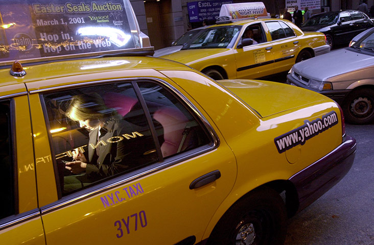 Yellow taxicabs: 2000: Woman using a PalmPilot in an internet taxicab