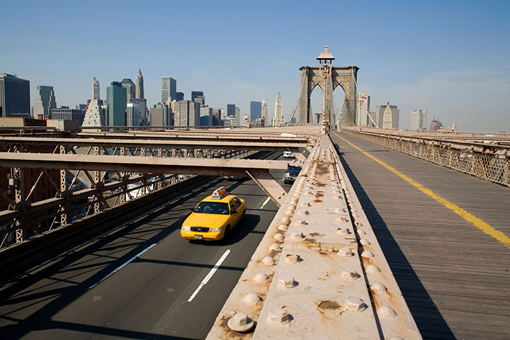 Yellow taxicabs: Yellow taxi cab on the Brooklyn Bridge leaving Manhattan, New York