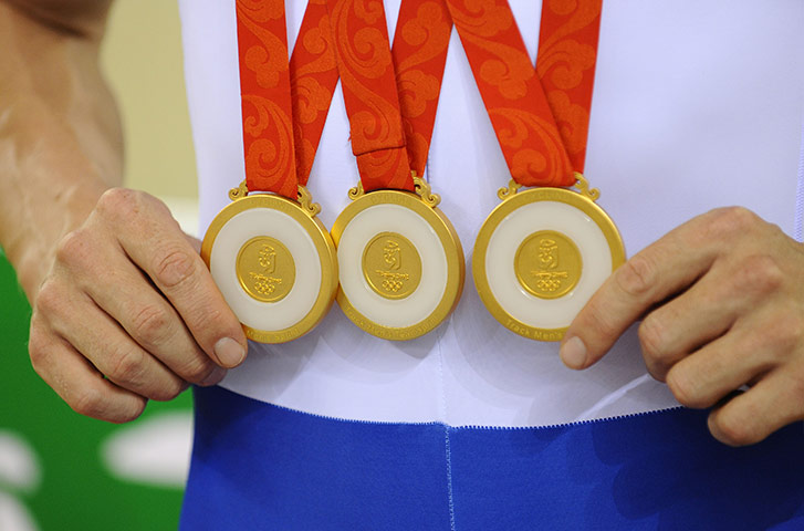 Olympic medals: Chris Hoy shows off his three gold medals after victory in the sprint