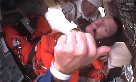 Space shuttle Atlantis commander Chris Ferguson gives a thumbs up