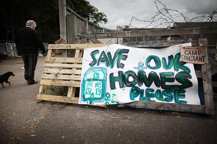 Dale Farm: 30 August 2011: A traveller walks past a 'save our homes' sign