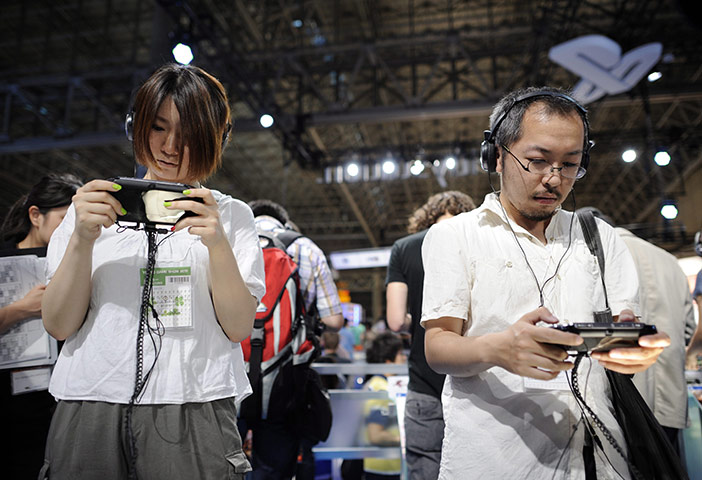 Tokyo Game Show: Visitors play with Sony Computer Entertainment's PlayStation Vita