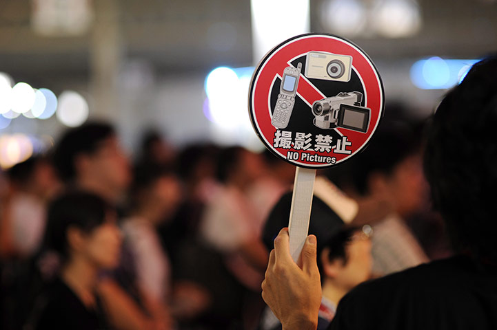 Tokyo Game Show: A staff member holds a 'No Pictures' sign