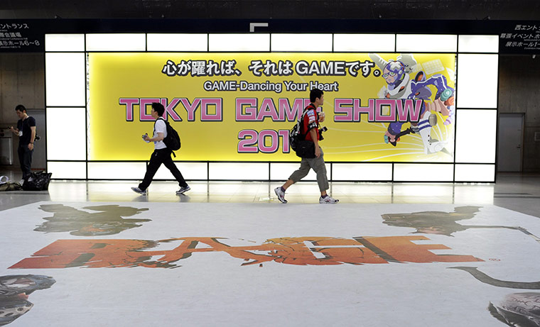Tokyo Game Show: Visitors walk past an advertising board