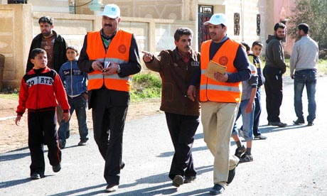 Handout photo of members from Arab League observers delegation visiting al-Msefra town near Deraa