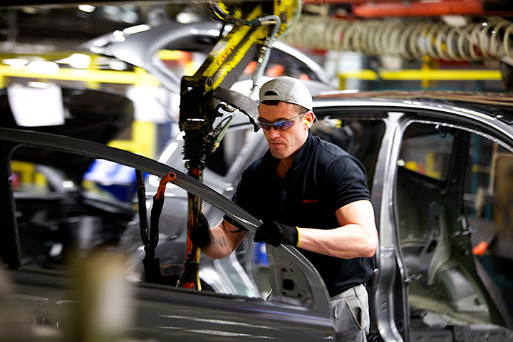 Nissan: An employee fits a car door