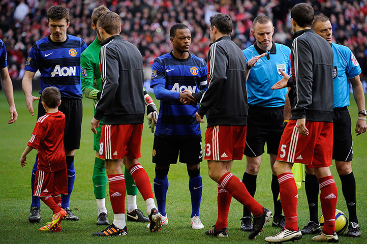 Liverpool v Man Utd: Patrice Evra shakes hands with the Liverpool players