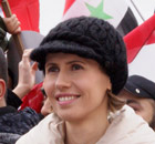 Asma al-Assad listens to a speech by her husband, President Bashar al-Assad