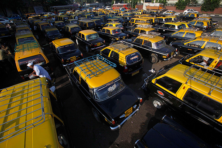 Mumbai taxis: A driver stands among parked taxis near Santa Cruz domestic airport, Mumbai