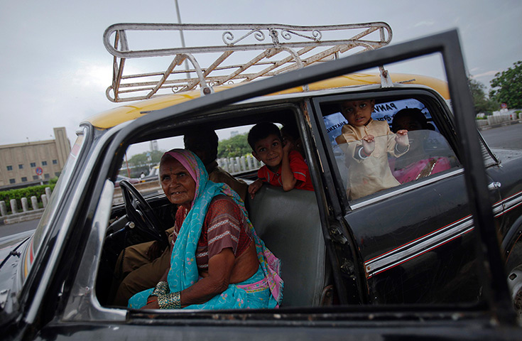 Mumbai taxis: A family looks out from a taxi 