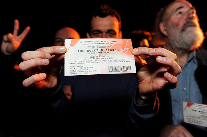 Week in music: One of 600 Rolling Stones fans holds up his ticket to a secret warm up gig