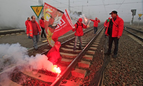Belgian workers with flares demonstrate on rail tracks and block trains during a European strike, at the North train station in Brussels November 14, 2012. 