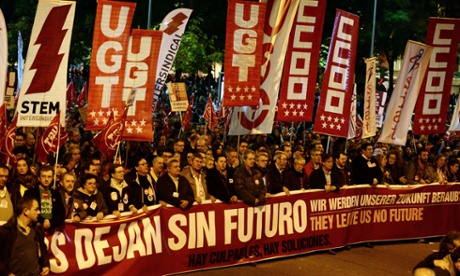 Protesters hold a giant banner in Madrid on November 14 2012.