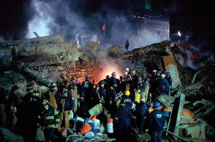 Joel Meyerowitz Monograph: Fire fighters work at the foot of the collapsed World Trade Centre