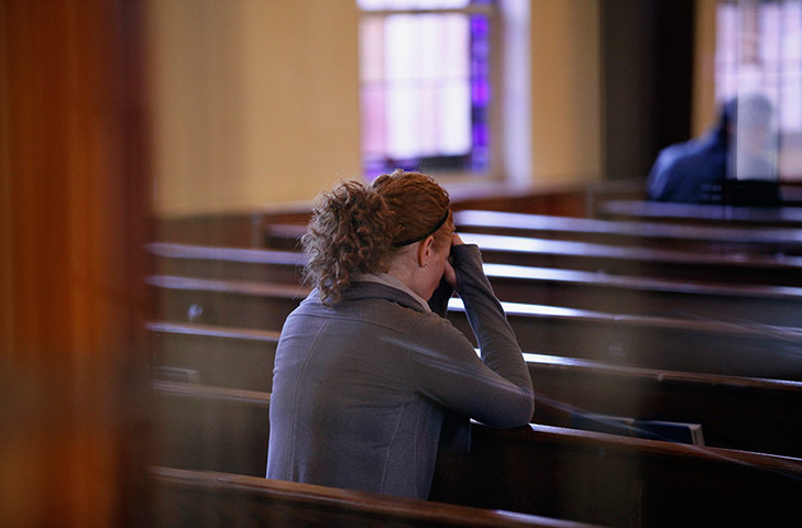 Newtown - the day after: A woman prays