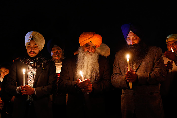 Newtown vigil: Members of the Sikh community hold a candlelight vigil 