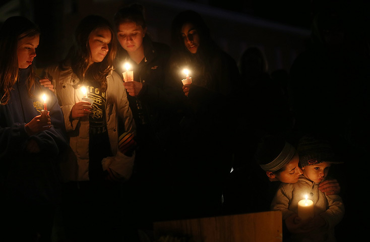 Newtown vigil: Newtown residents hold candles at a memorial for victims 