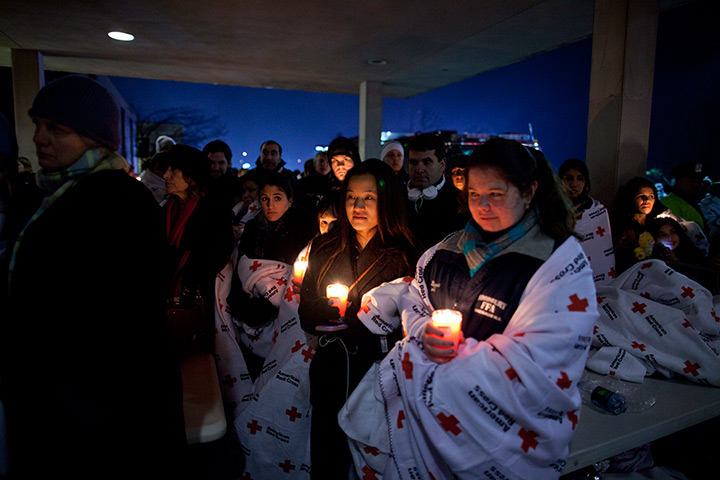 Newtown vigil: Residents hold a candlelight vigil outside Newtown High School