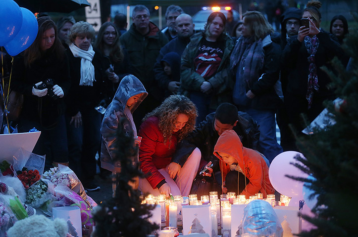 Newtown vigil: People gather at a memorial for victims near the school 