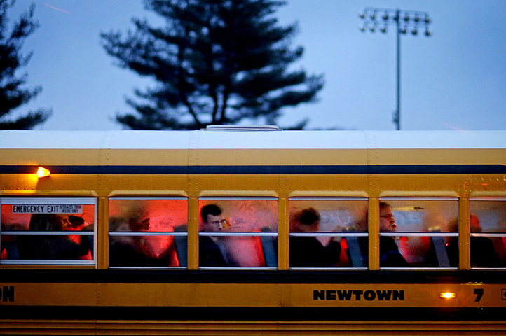 Newtown vigil: People arrive on a school bus for a memorial vigil 