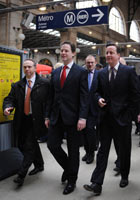 Nick Clegg and David Cameron arrive at Gare du Nord station in Paris on 17 February 2012.