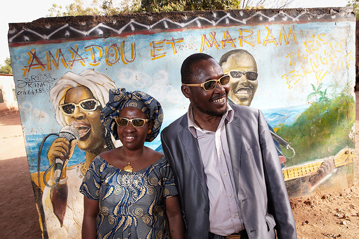 Amadou and Mariam: Amadou and Mariam stand in front of a mural inside the school for the blind