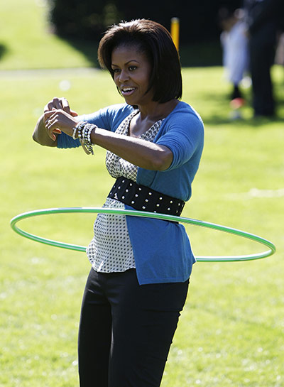 Michelle Obama fitness: Michelle Obama exercises with a hula hoop during a healthy kids fair