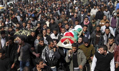 Palestinian mourners carry the bodies of people killed in Israeli air strikes on the Gaza Strip