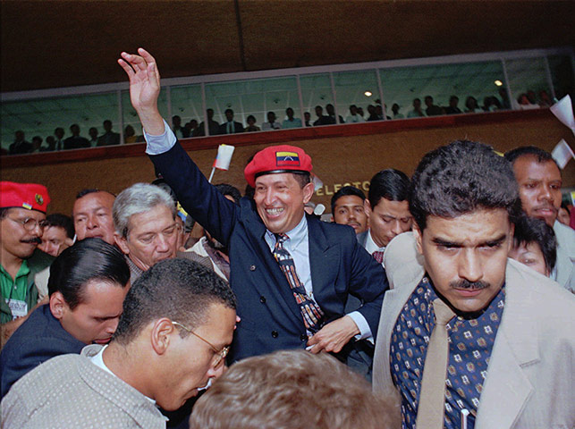 Hugo Chávez waves after announcing his candidacy for the presidency in 1997