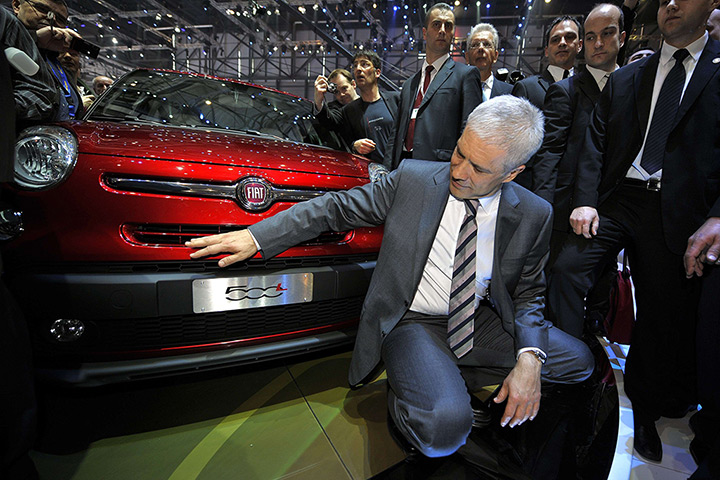 Geneva motor show: Serbian President Boris Tadic poses next to a new Fiat 500L