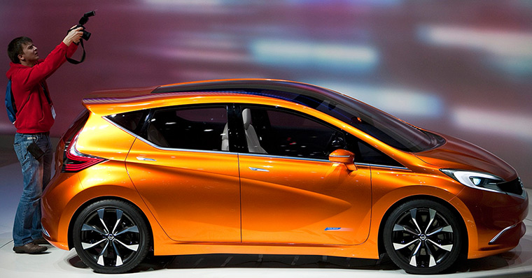 Geneva motor show: A man takes pictures of the new Nissan Invitation concept car 