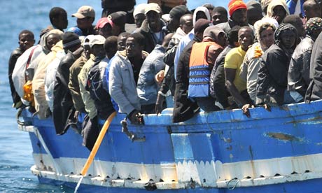 A boat full of migrants arrives at the Italian island of Lampedusa in April 2011