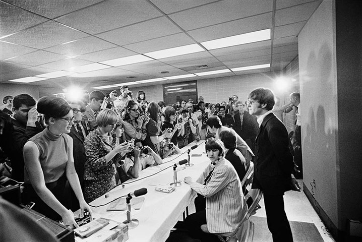 Harry Benson: John stands to answer a question at the press conference, Memphis 1966